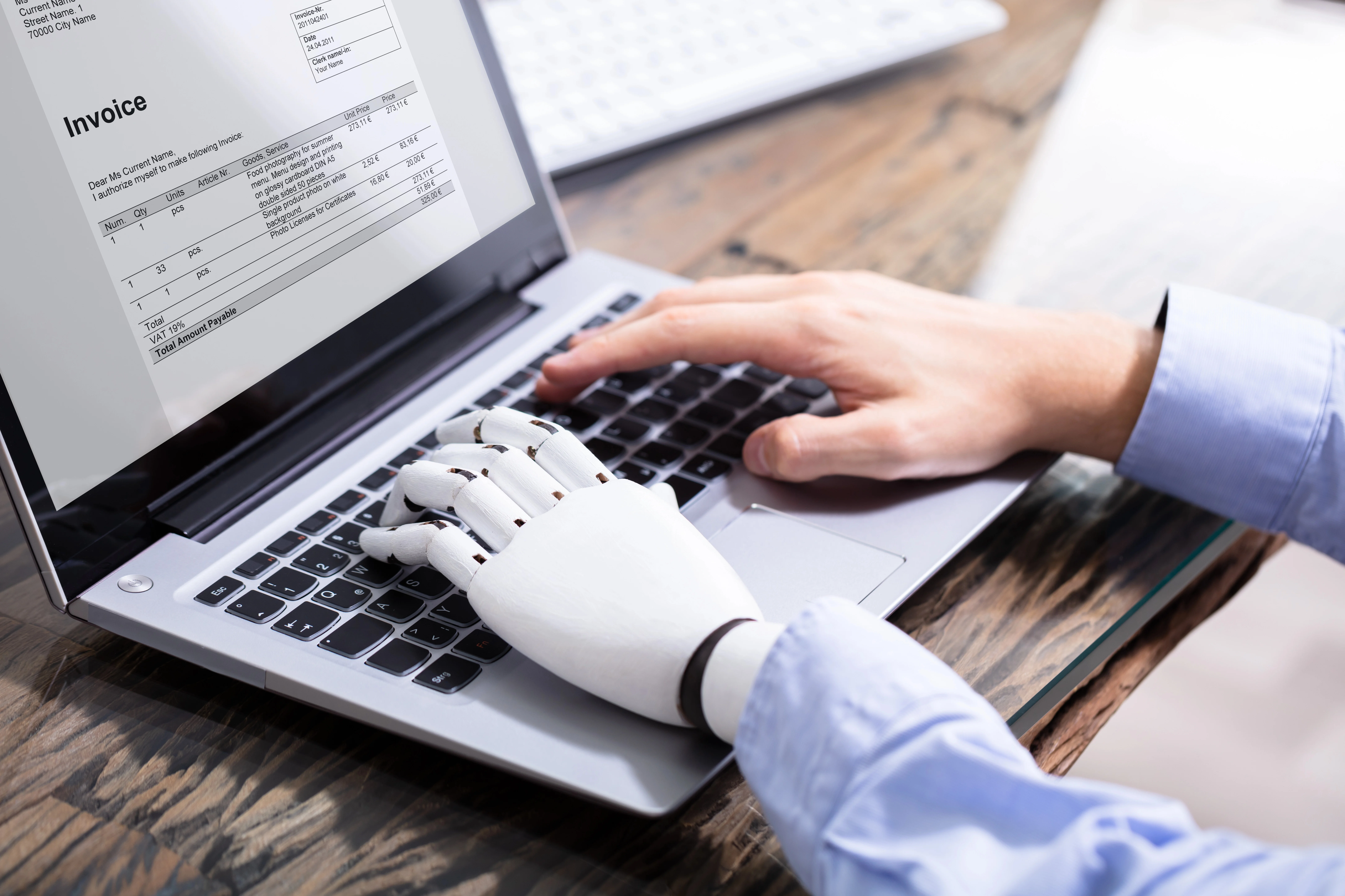 Employee using laptop with AI assistance, highlighting hidden workplace AI use and productivity support.